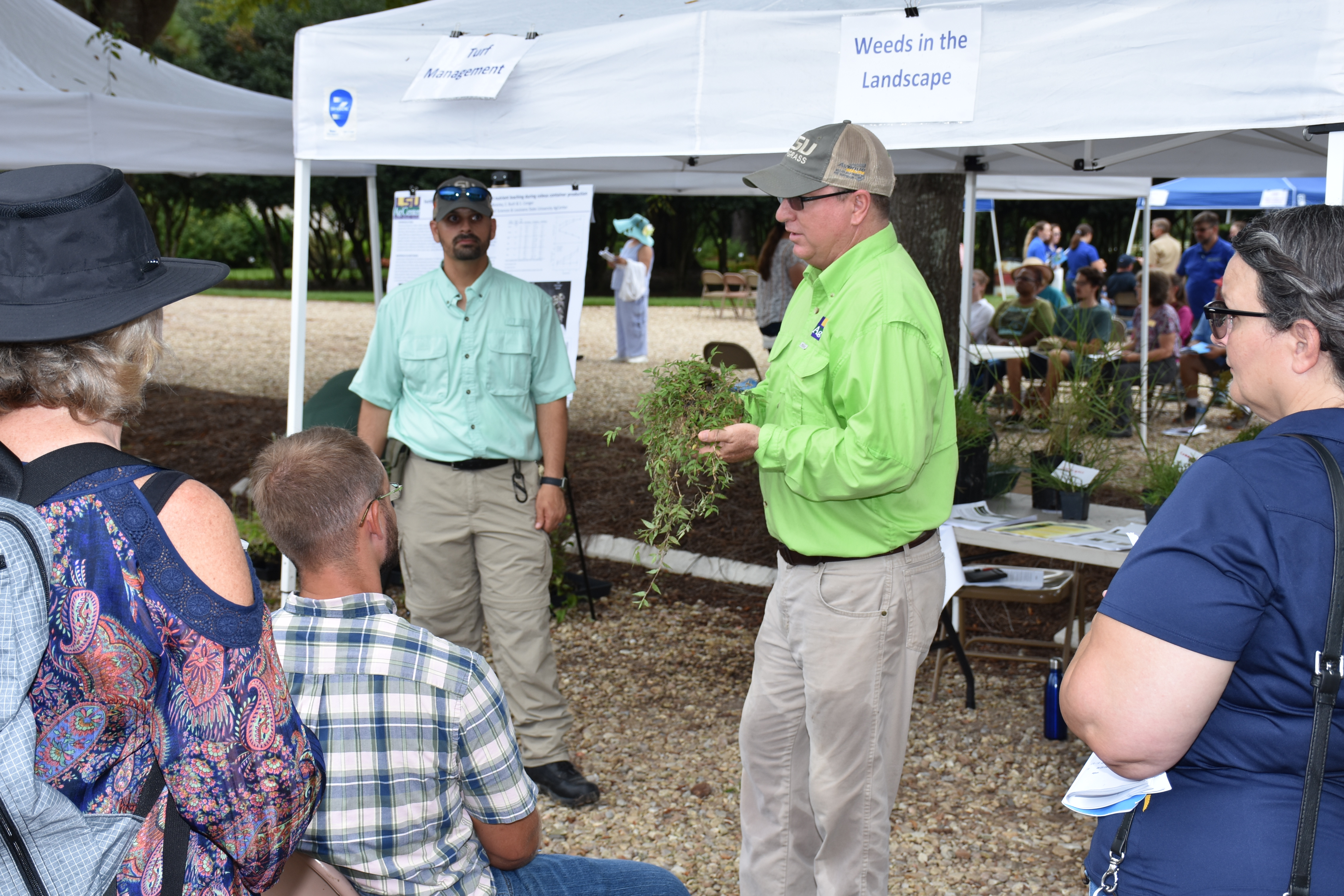AgCenter weed scientist Ron Strahan holds a pot containg weeds at the Hammond Landscape Field Day.